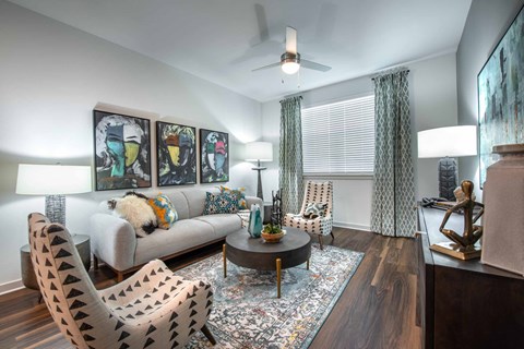 a living room with furniture and a ceiling fan